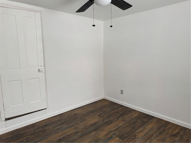 empty room with ceiling fan and dark hardwood / wood-style flooring