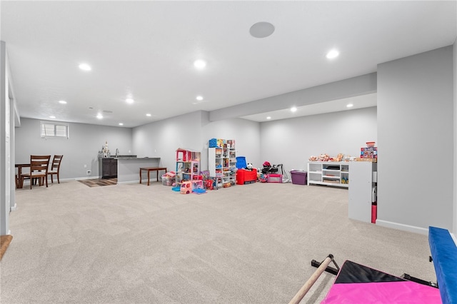 recreation room featuring light carpet