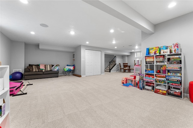 recreation room with light colored carpet