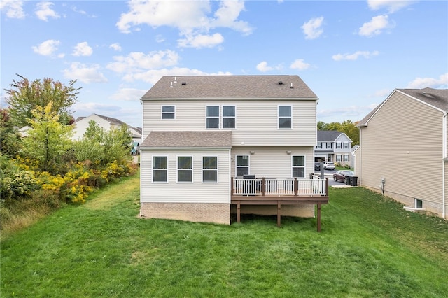 back of house featuring a wooden deck and a lawn