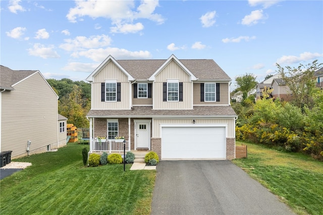 view of front facade featuring a garage, a front lawn, and a porch