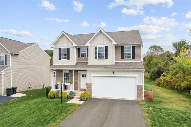 view of front of property with a front yard, a garage, and a porch