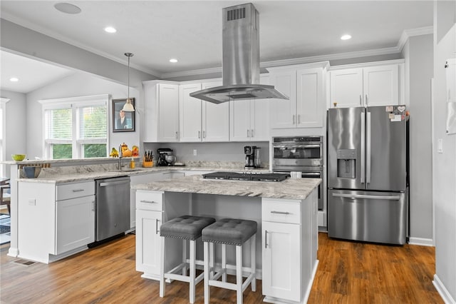 kitchen with island exhaust hood, stainless steel appliances, white cabinets, and a center island