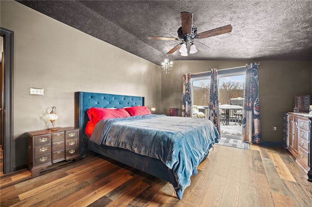 bedroom featuring vaulted ceiling, ceiling fan, hardwood / wood-style flooring, and access to outside