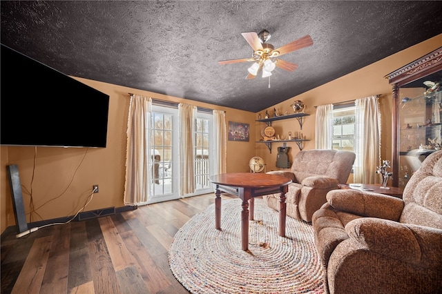 living room with ceiling fan, hardwood / wood-style floors, and lofted ceiling