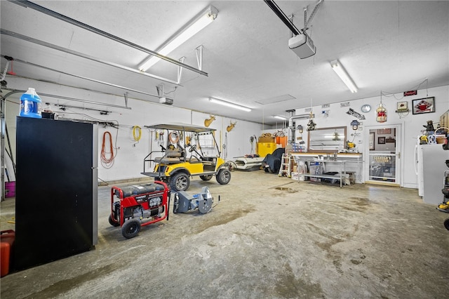 garage with a workshop area and a garage door opener