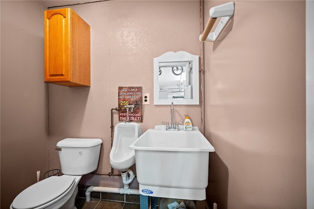 bathroom featuring sink, toilet, and tile patterned flooring