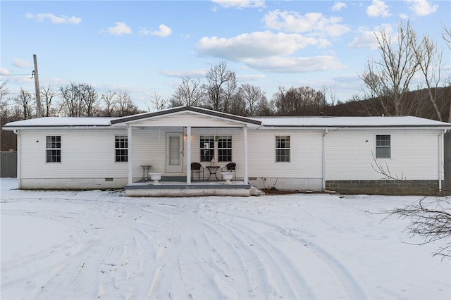 snow covered property featuring a porch