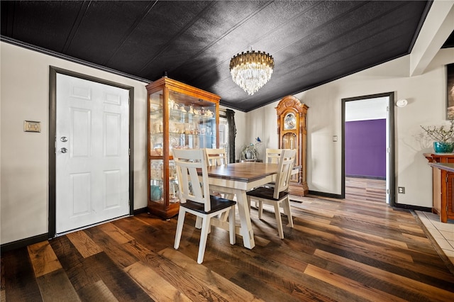 dining room featuring ornamental molding, a chandelier, and hardwood / wood-style flooring