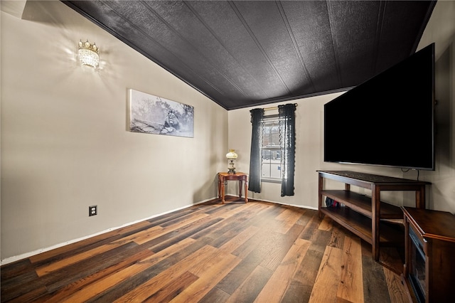 living room featuring wood-type flooring, vaulted ceiling, and crown molding