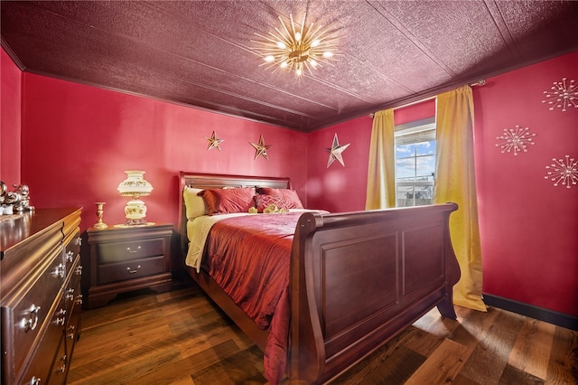 bedroom with dark hardwood / wood-style floors and ornamental molding