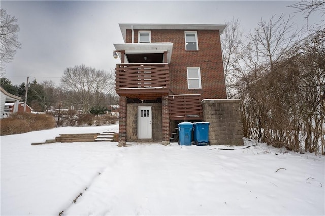 view of snow covered rear of property