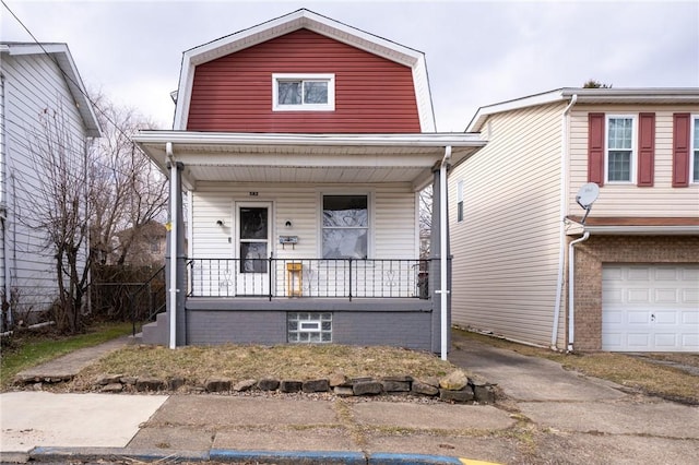 view of front of property with a garage and covered porch