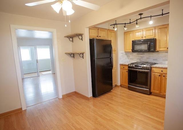 kitchen featuring ceiling fan, light hardwood / wood-style floors, backsplash, and black appliances