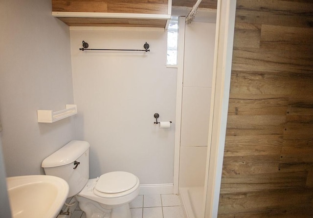 bathroom featuring toilet, tile patterned floors, and sink