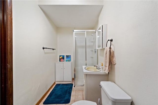 bathroom with a stall shower, baseboards, toilet, tile patterned floors, and vanity