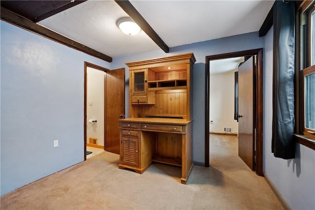 office with light carpet, baseboards, visible vents, and beamed ceiling