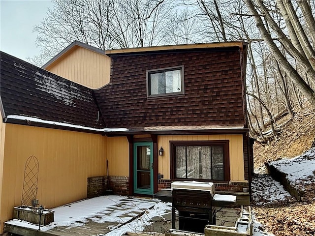 exterior space featuring a patio and roof with shingles