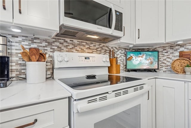 kitchen featuring white cabinets, white electric range oven, tasteful backsplash, and light stone countertops