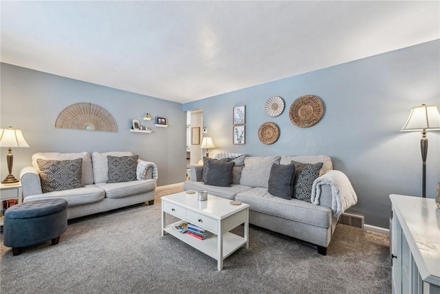 living room with dark colored carpet