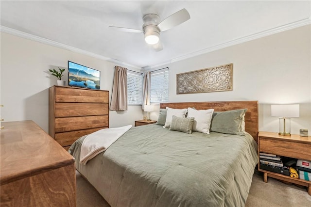 carpeted bedroom featuring ceiling fan and ornamental molding