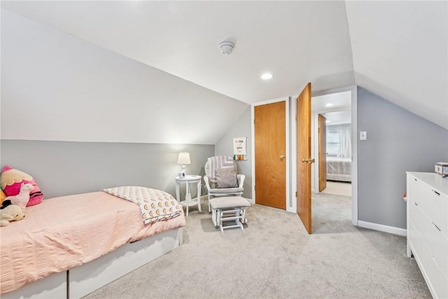 bedroom featuring light carpet and vaulted ceiling