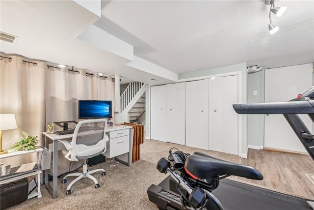 office area with light colored carpet and rail lighting