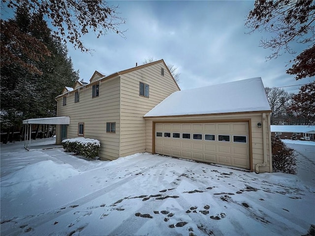 snow covered property featuring a garage