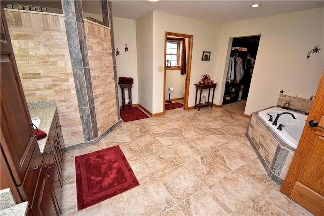 bathroom featuring shower with separate bathtub and vanity