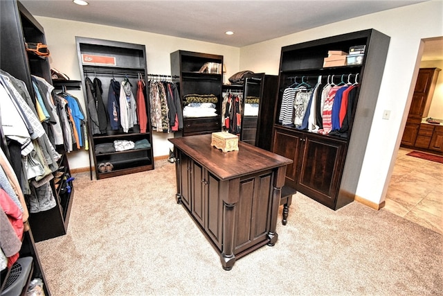 spacious closet featuring light carpet