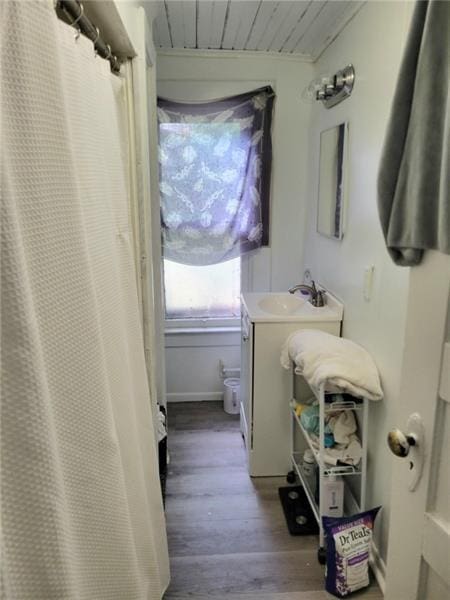 bathroom featuring vanity, wood ceiling, and hardwood / wood-style flooring