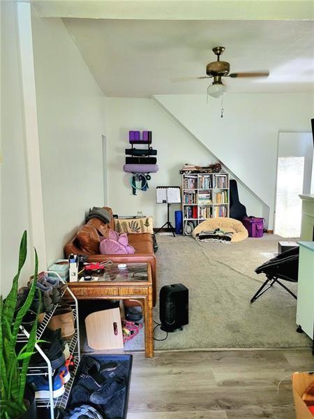 interior space with ceiling fan and wood-type flooring