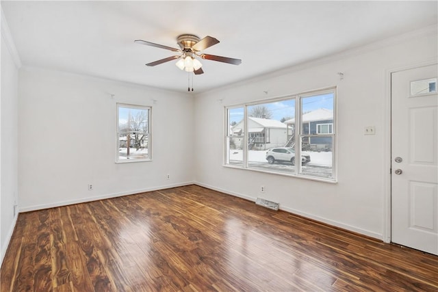 unfurnished room with ceiling fan, dark hardwood / wood-style floors, and ornamental molding