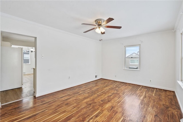 empty room with ceiling fan, dark hardwood / wood-style floors, and crown molding