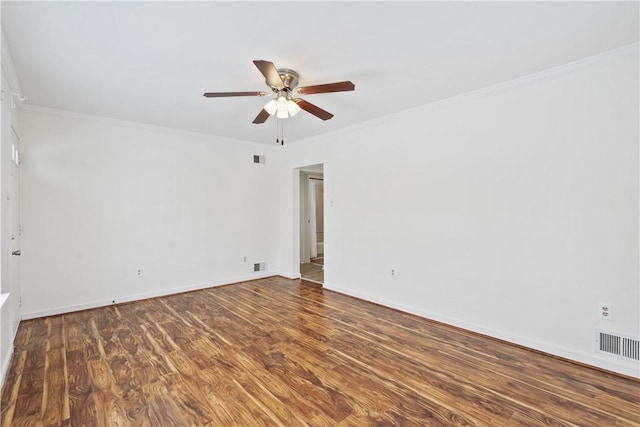 empty room featuring ceiling fan, dark hardwood / wood-style flooring, and ornamental molding