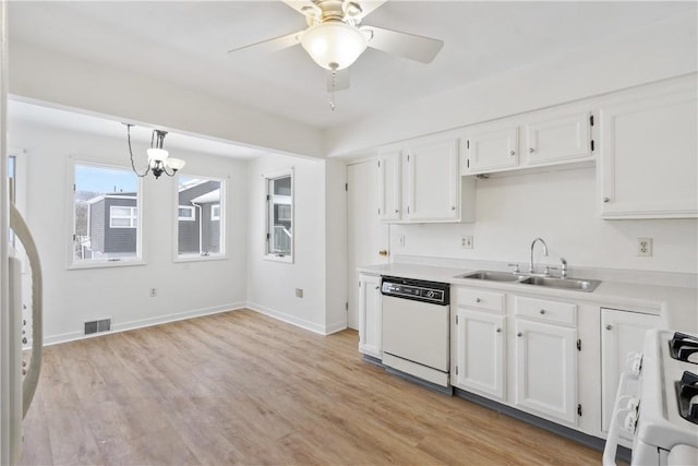 kitchen with sink, white appliances, white cabinetry, light wood-type flooring, and ceiling fan with notable chandelier