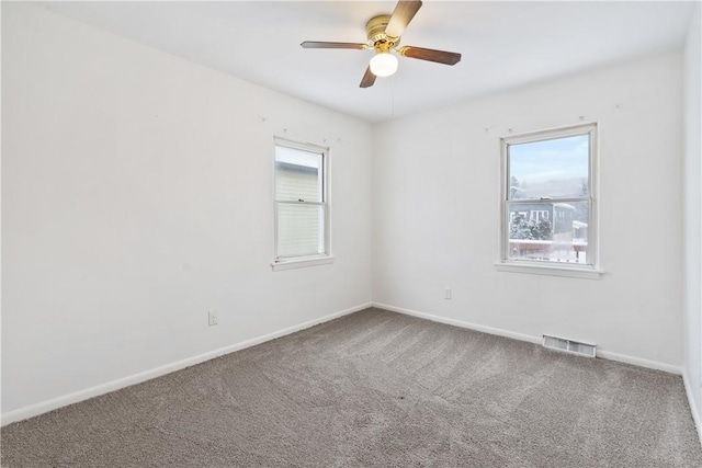 empty room featuring ceiling fan and carpet flooring