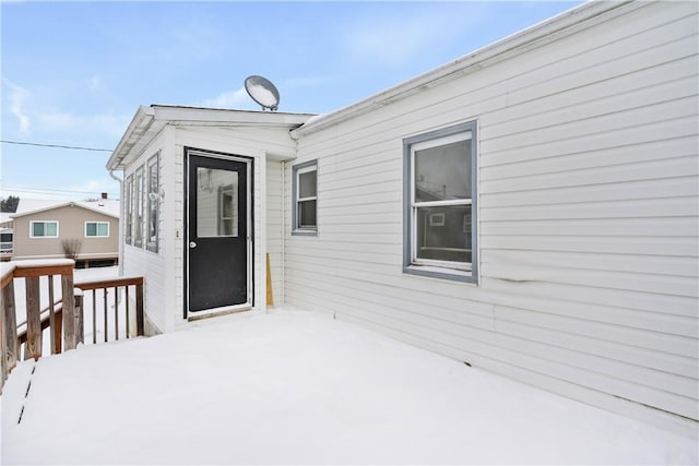 view of snow covered property entrance