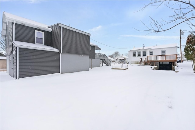 snowy yard featuring a deck