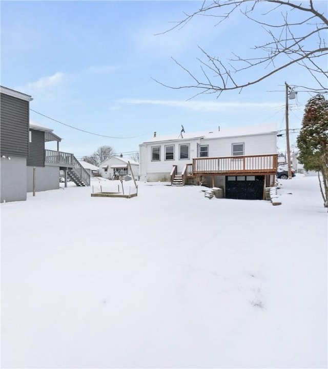 snow covered house with a deck