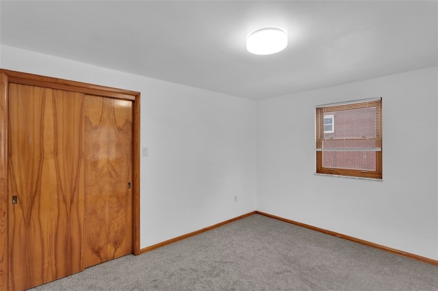 unfurnished bedroom with a closet and carpet flooring