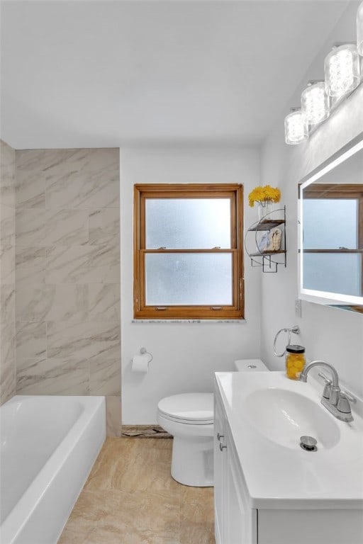 bathroom featuring toilet, tile patterned flooring, a healthy amount of sunlight, and vanity