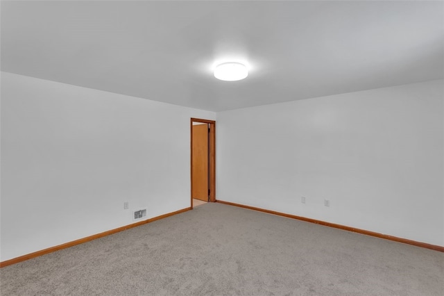 unfurnished room featuring light carpet