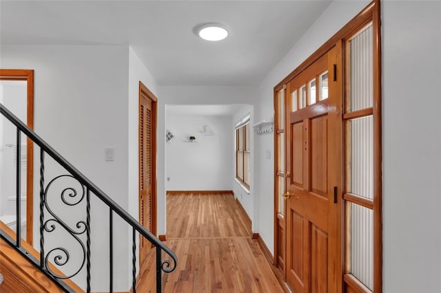 corridor with light hardwood / wood-style flooring