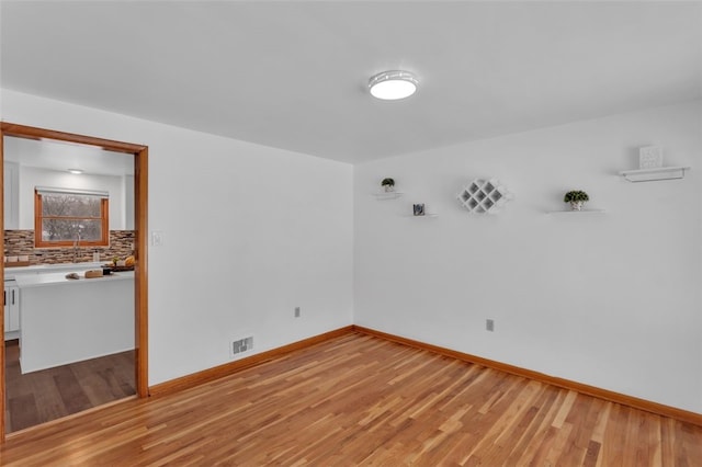 spare room featuring light hardwood / wood-style floors