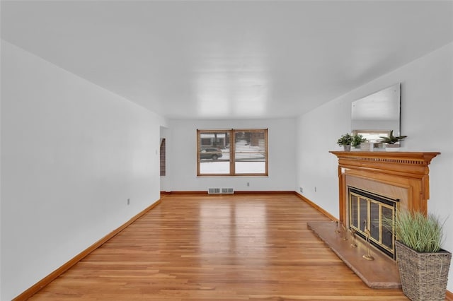 unfurnished living room featuring light hardwood / wood-style floors and plenty of natural light