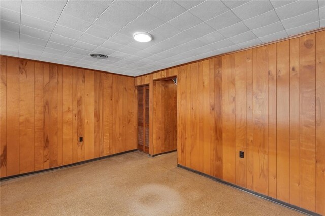 spare room featuring wooden walls