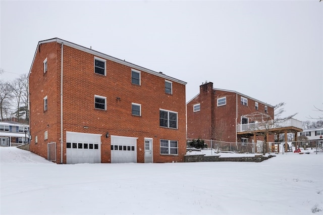 snow covered building featuring a garage