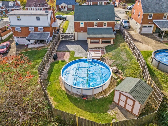 view of pool with a storage shed