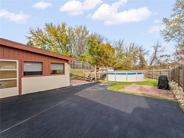 garage with a fenced in pool